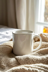 Fototapeta na wymiar White mug sits on knitted blanket by window.