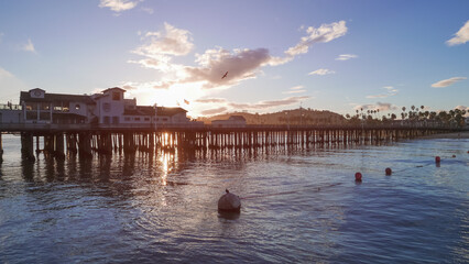 Naklejka premium Stearns Wharf on a beautiful pacific sunset after a recent rain coastline beach shore in Santa Barbara, California. Shot on a beautiful pacific sunset after a recent rain.