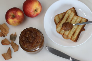 Homemade apple jam spread on bread toast