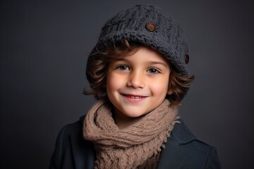 Portrait of a cute little boy in winter hat and scarf.