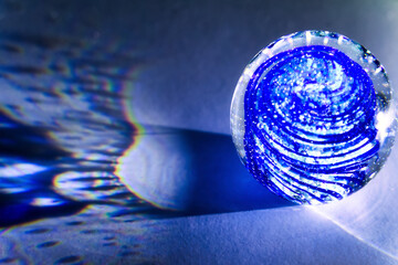 A transparent glass ball with inclusions casts real shadows