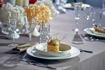 Salad with mayonnaise, chicken, peas, carrots and poached egg. A modern take on Ukrainian salad Olivier