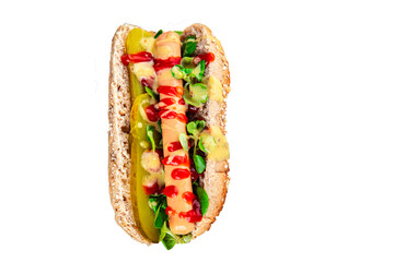 Hot Dog sausage bun, tomato sauce, pickled cucumber, green lettuce leaf takeaway food tasty fresh eating appetizer meal food snack on the table copy space