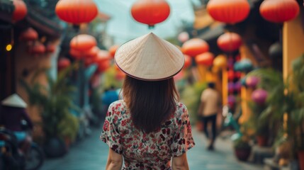 A young woman stands with her back and admires the view of the Asian street. A traveler traveling on vacation in the most beautiful place in the world. Summer vacation