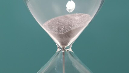 Hourglass sand detail. Concept of time passing. - Powered by Adobe