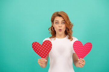surprised young girl with red heart on blue background