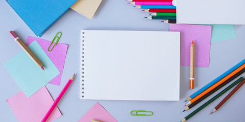 Back to school, stationery, notepad, books, paper and colored pencils on the student's desk, top view, flatley, copy space