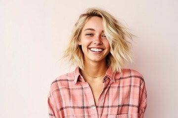 Portrait of a beautiful young woman with blond hair in a checkered shirt