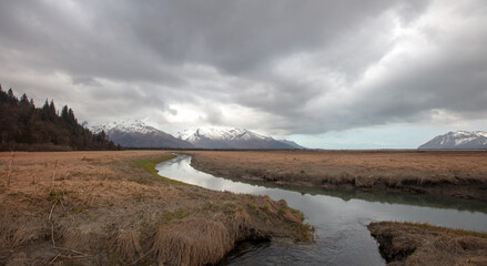Gray cloudscape over river and mountains near Chinitna Bay Alaska United States