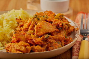 Chicken curry with turmeric rice shot close up to the curry.