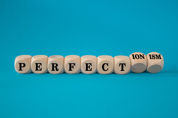 Perfectionism symbol. Concept words Perfect or Perfectionism on beautiful wooden cubes. Beautiful...