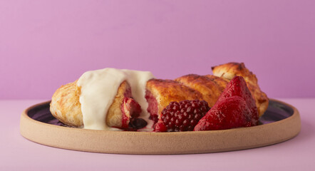 Mixed fruit pie topped with cream and honey.