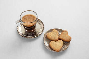 Cup of coffee and heart-shaped cookies for Valentine's Day