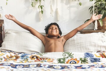 Joyful Boy Stretching on Bed with Hands Up in Air in Bright Bedroom