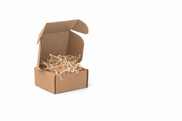 Cardboard box with kraft paper filling on white background. Copy space.        