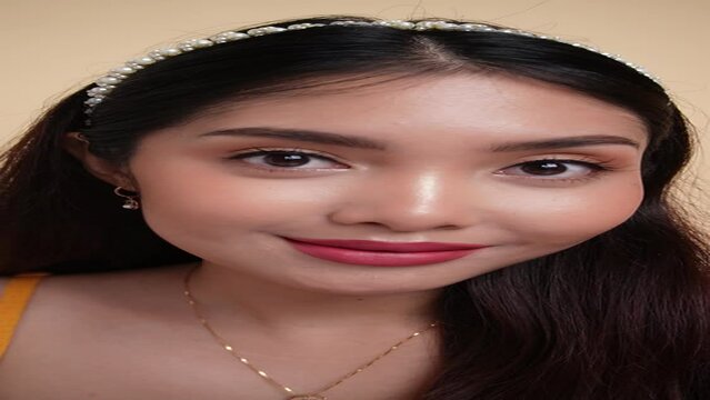 Asian woman with beautiful makeup and false lashes.