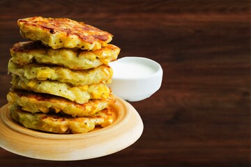 Top view of a plate of corn fritters.Perkedel Jagung or Bakwan Jagung. Corn fritters is Indonesian traditional food. Savory snack made of corn, flour, spring onion, and salt. Vegetarian food,Thai food