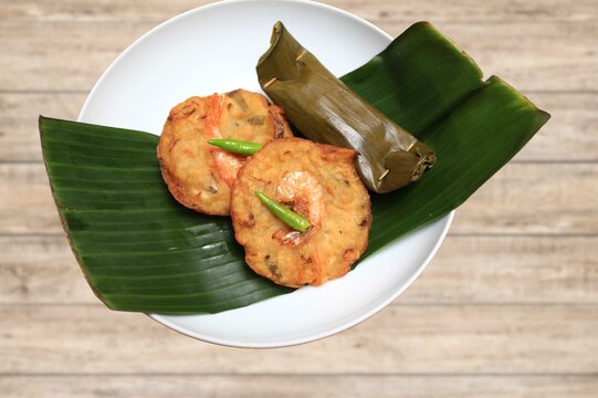 Corn Fritters with Corn. Healthy and Diet Food . Crispy fried corn ball in a white plate on wooden table, Vegetarian food, Thai food, snacks Thai style. Zucchini fritters or vegetarian zucchini pancak