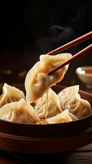 chinese dim sum,Chinese Dumplings with Chopsticks and Sauce
