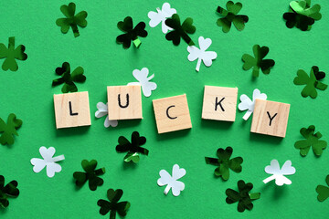Lucky Saint Patrick's Day green background with green and white shamrock clover confetti, St....