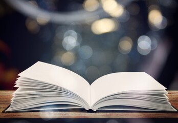 open antique reading book on table