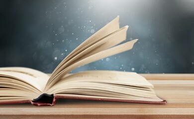 open antique reading book on table