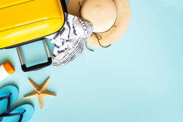 Travel background, summer holidays. Suitcase, passports, hat and summer cloth on blue background....