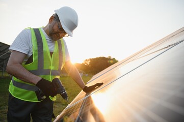 Worker installing solar panels outdoors