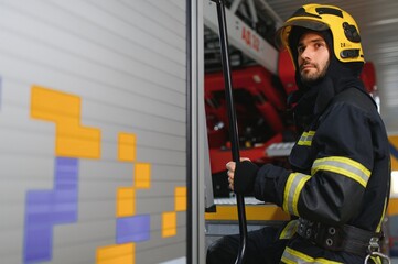 Photo of fireman with gas mask and helmet near fire engine