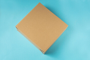 Empty paper cardboard box on the blau background.