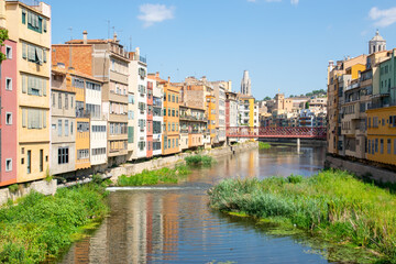 Street with balcony in the old summer city in Spain near the river.