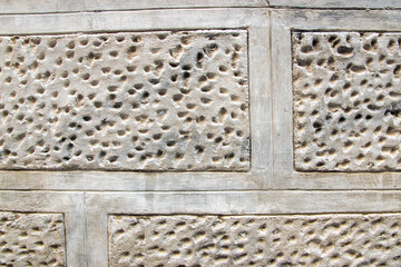 Stone wall with old bricks of the acient castle. Gray brick surface.