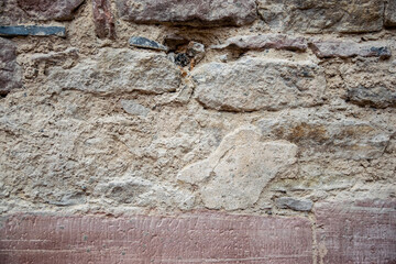 Stone wall with old bricks of the acient castle. Gray brick surface.