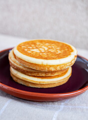 Golden pancakes in close-up on a gray background - 734212716