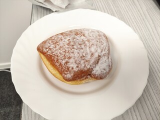 Donut with powdered sugar on the plate