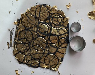 Working on black clay with cutters and gold leaf