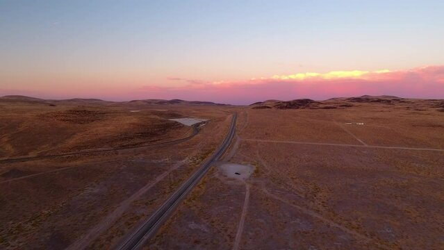 Aerial Forward Scenic Shot Of Tranquil Semi Arid Desert Against Cloudy Sky During Sunset - Ely, Nevada