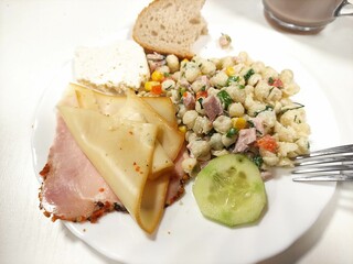 Olivier salad, carbonade and vegetables on a plate