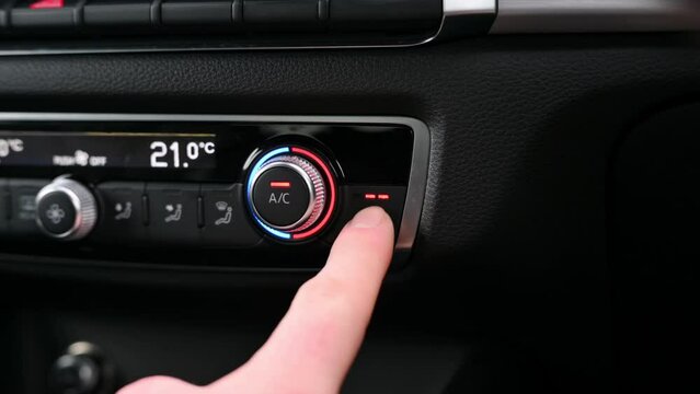 Close up of heated seat controls being pressed