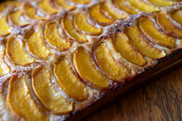peach tart and fresh fruit closeup on wooden background horizontal view from above
