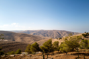 Fototapeta na wymiar Overlooking the holy land from mount nebo, where Moses stood when talking to god, and curing plague from serpent staff. Jordan, Israel, Palestine and Gaza visible from this hill. Jesus' baptism site