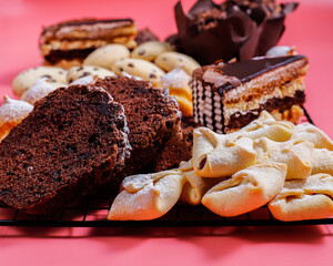 Table with various cookies, pound cake, cake slices, muffins and sweets.