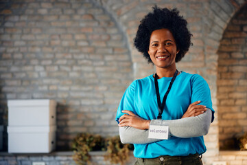 Confident black woman volunteering at donation center and looking at camera.