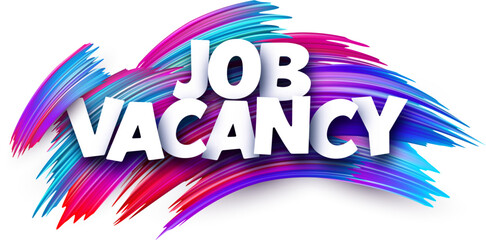 Job vacancy paper word sign with colorful spectrum paint brush strokes over white.