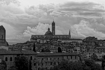 Fototapeta premium Siena Italy 09 30 2022: Old Medieval city in Tuscany in Europe. Art and culture. Tourists from all over the world for Piazza del Campo Palio Duomo Tower del Mangia and the oldest bank banco dei Paschi