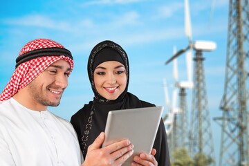 Young engineer working on windmills background.