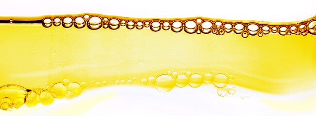 Hydrophilic oil close-up, bubbles in the yellow liquid. Cosmetic essence, luxury skin care with...