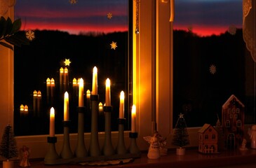 Illuminated window with Christmas decoration, winter evening
