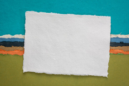 small sheet of blank white Khadi rag paper from India against abstract landscape