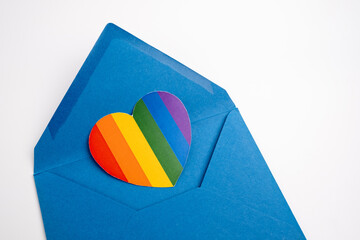 Rainbow heart on a white envelope and color background. LGBT flag. LGBTQIA Pride Month in June....